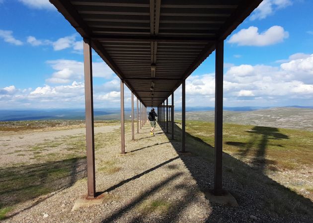 A gate on top of a mountain leading to the unknown