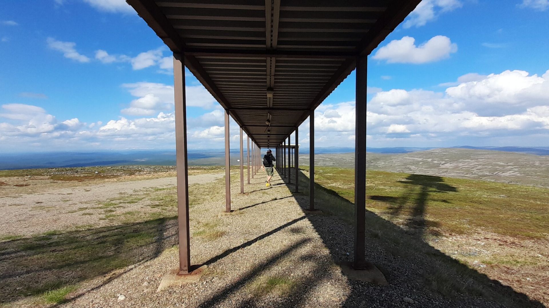 A gate on top of a mountain leading to the unknown